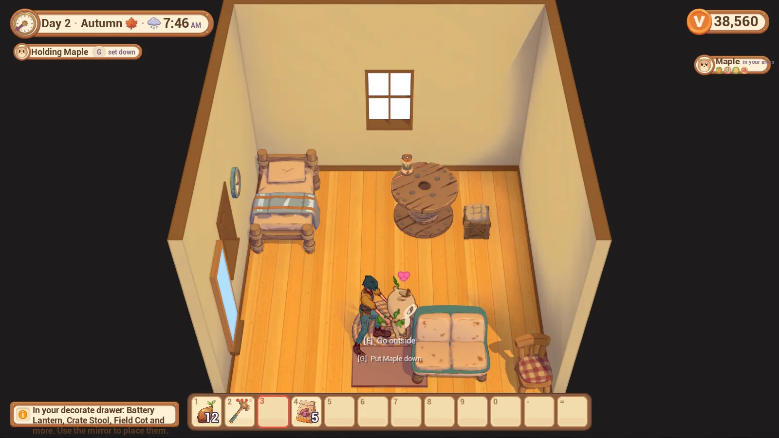 A top-down view into a small room with wooden floors: a bed with a striped blanket, a cable-spool table with a lamp, a crate stool, a cushioned two-seat sofa and a checked chair; the caretaker stands on a rug by the door holding a small creature, with a clock on the wall